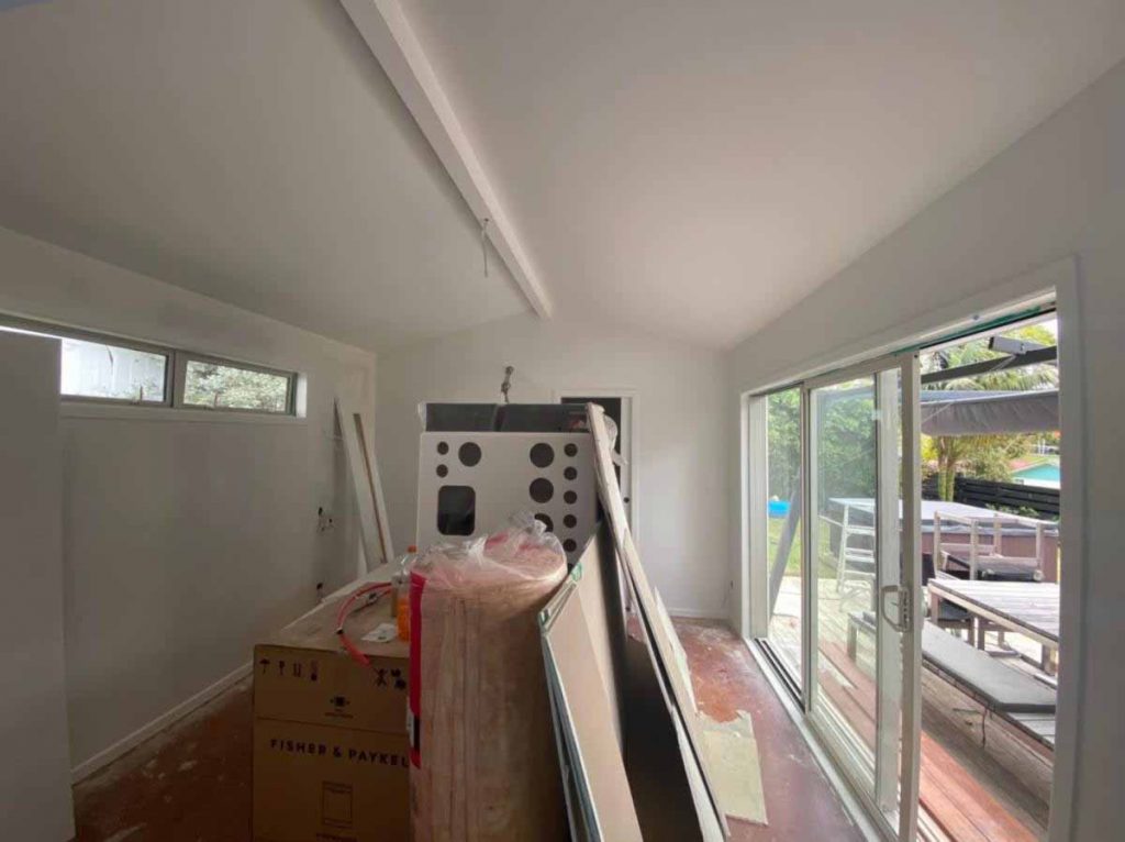 Interior room preparation before house painting with walls protected and fixtures being removed